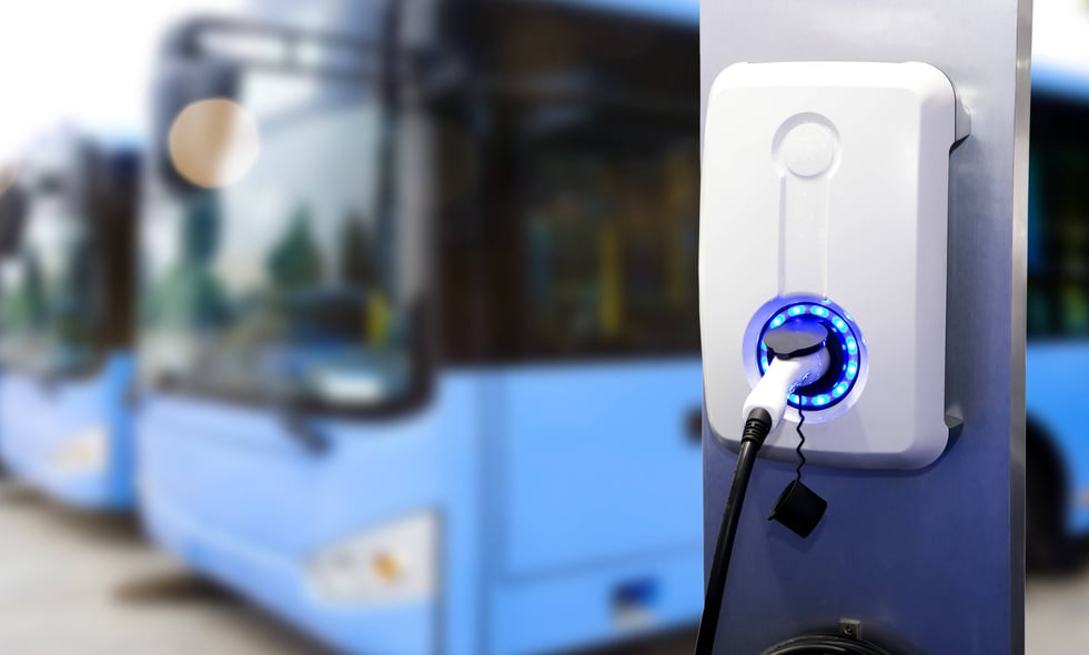 EV charger next to row of buses