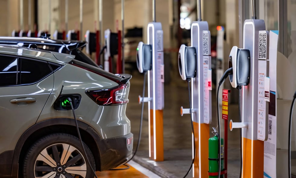 EV charger plugged into a car inside car park